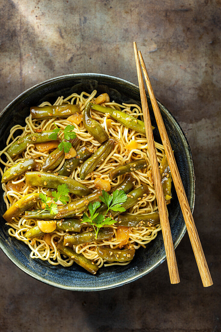 Fried Asian noodles with green beans and sesame seeds