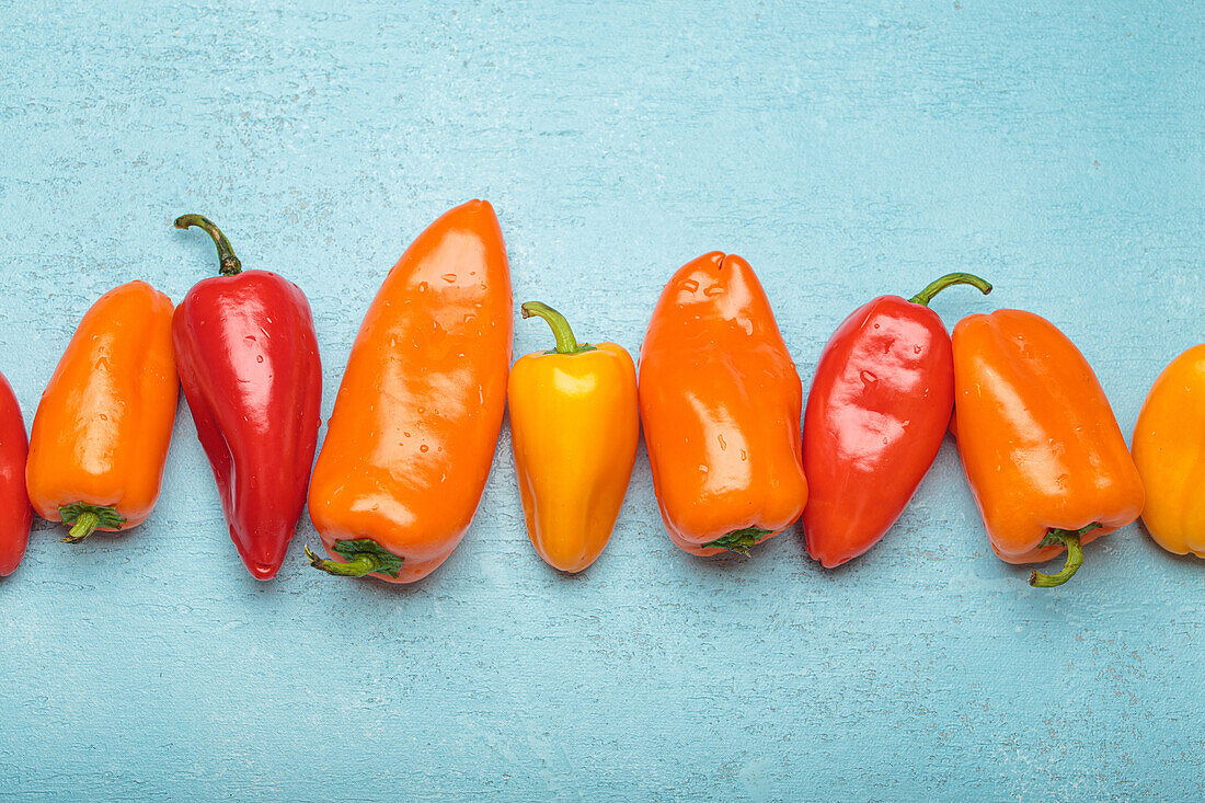 Various colourful peppers in a row