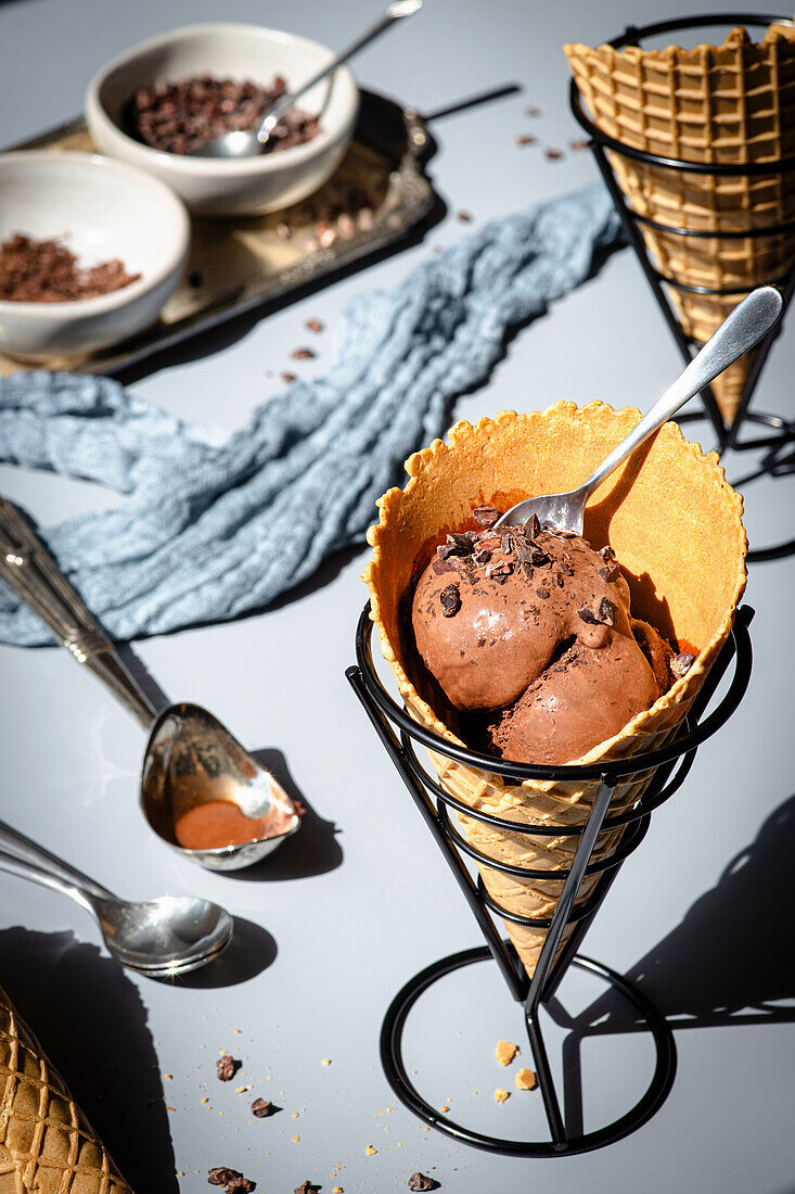 Chocolate ice cream in an ice cream cone with chocolate sprinkles