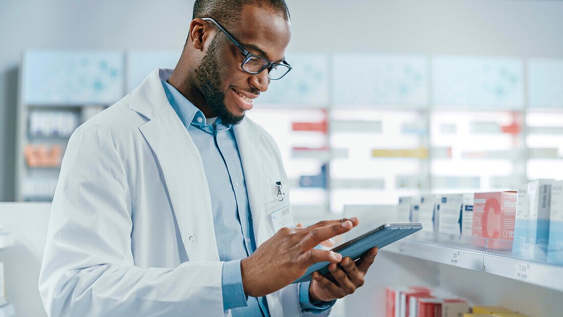 Pharmacist using tablet in pharmacy