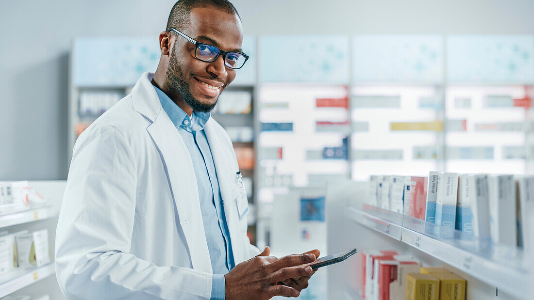 Pharmacist smiling in pharmacy