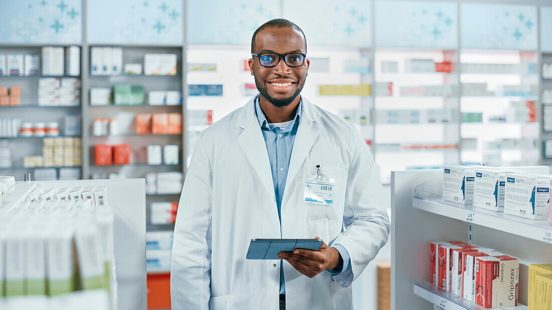 Pharmacist smiling in pharmacy