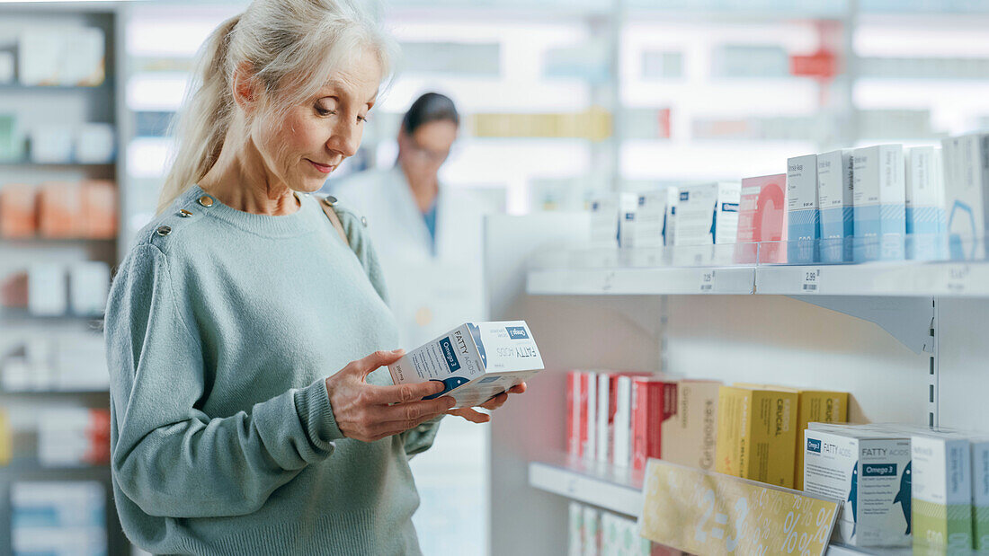 Female customer holding box of medicine