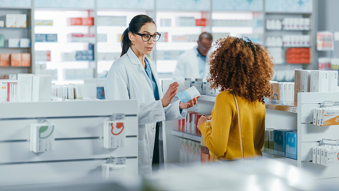 Pharmacist talking to female customer