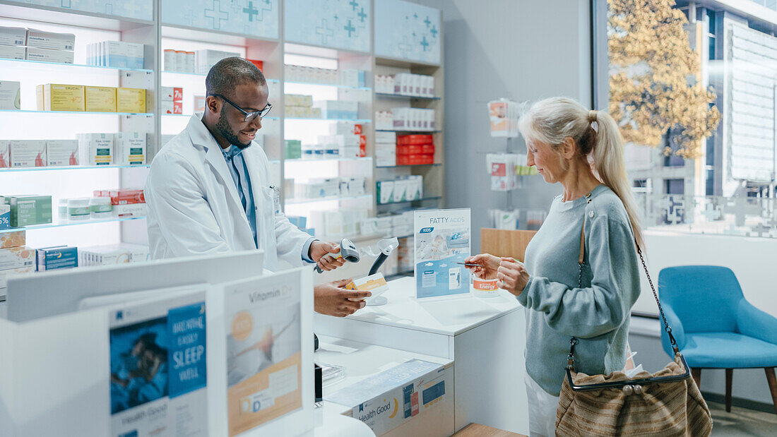 Female customer paying at pharmacy checkout