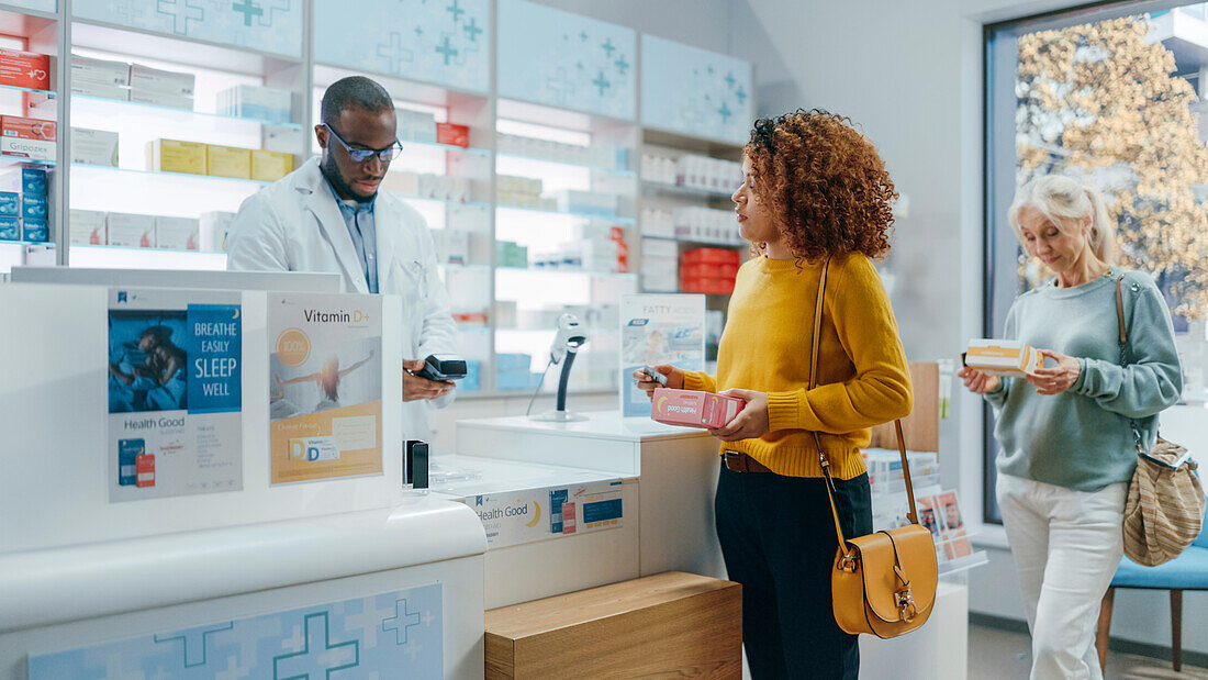 Female customer paying at pharmacy checkout