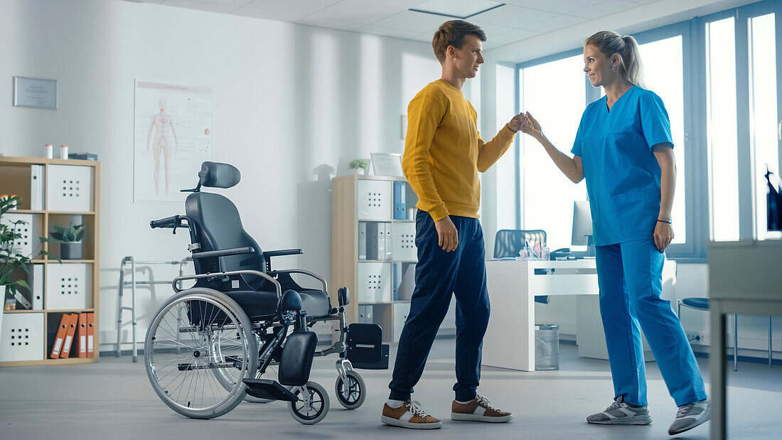 Male patient being assisted by physiotherapist