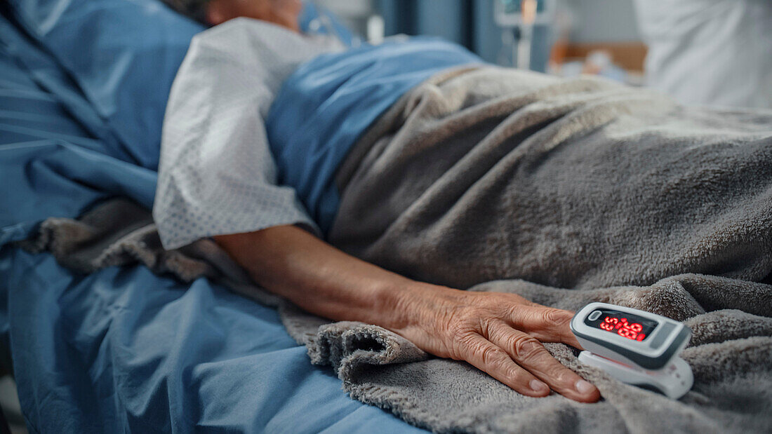 Elderly patient wearing pulse oximeter