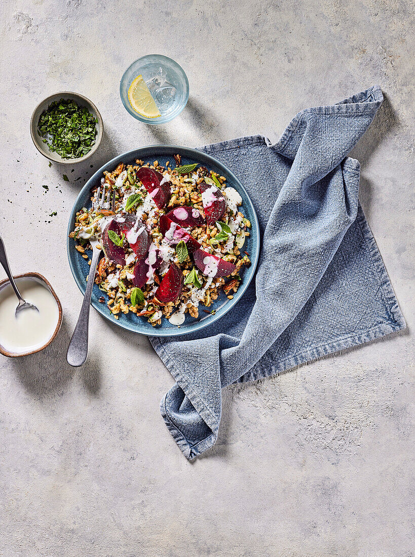 Salad with cooked grains, beetroot and herbs