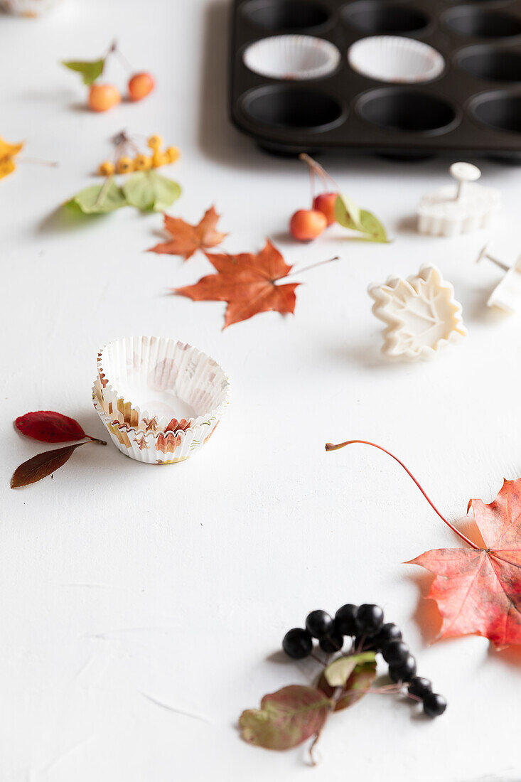 Autumn muffin cases with maple leaves and wild fruit