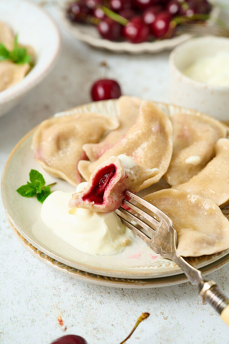 Sour cherry pierogi served with cream