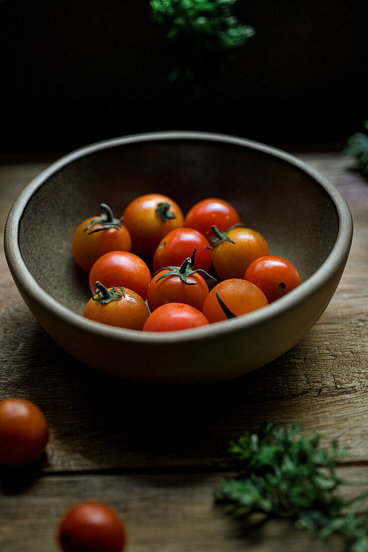 Still life of a bowl of fresh cherry tomatoes