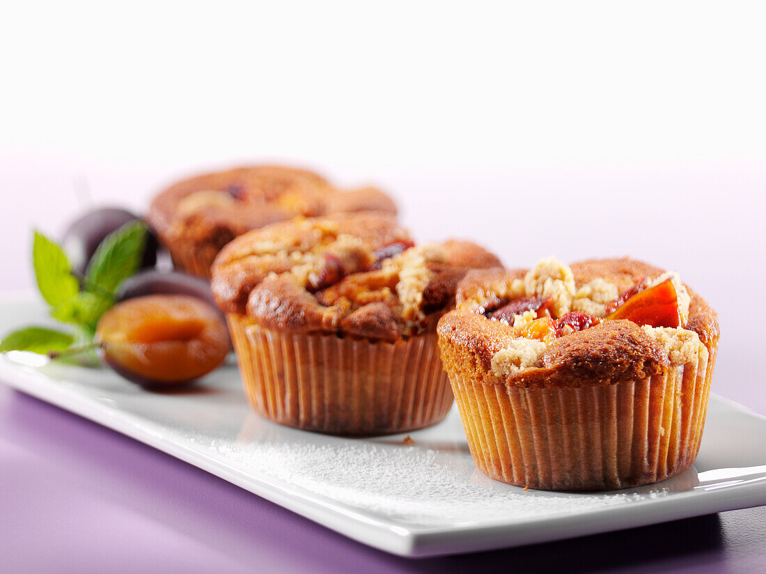 Plum muffins on a white plate