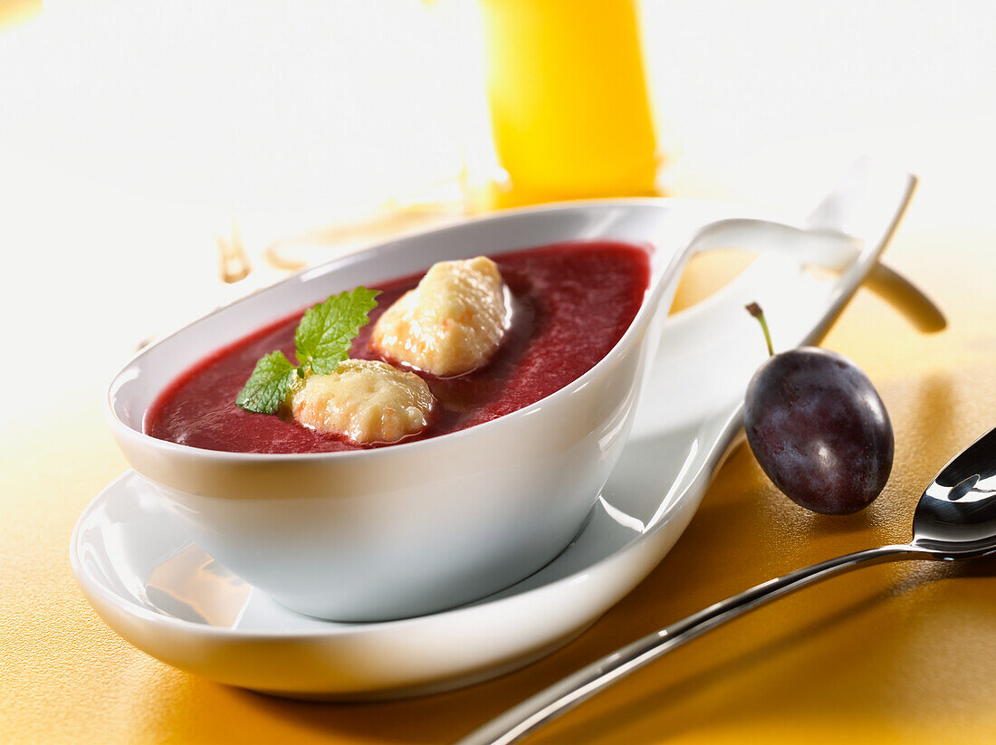 Plum soup with sweet semolina dumplings and mint