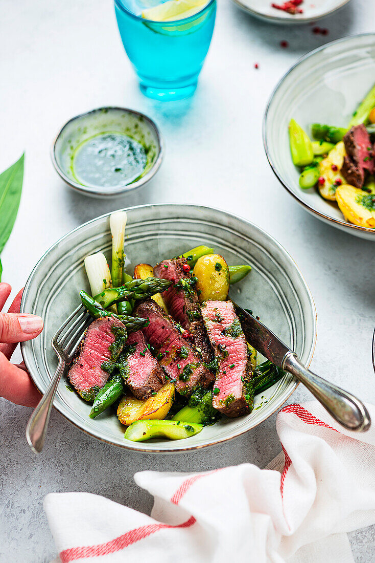 Beef steak with wild garlic oil and spring vegetables