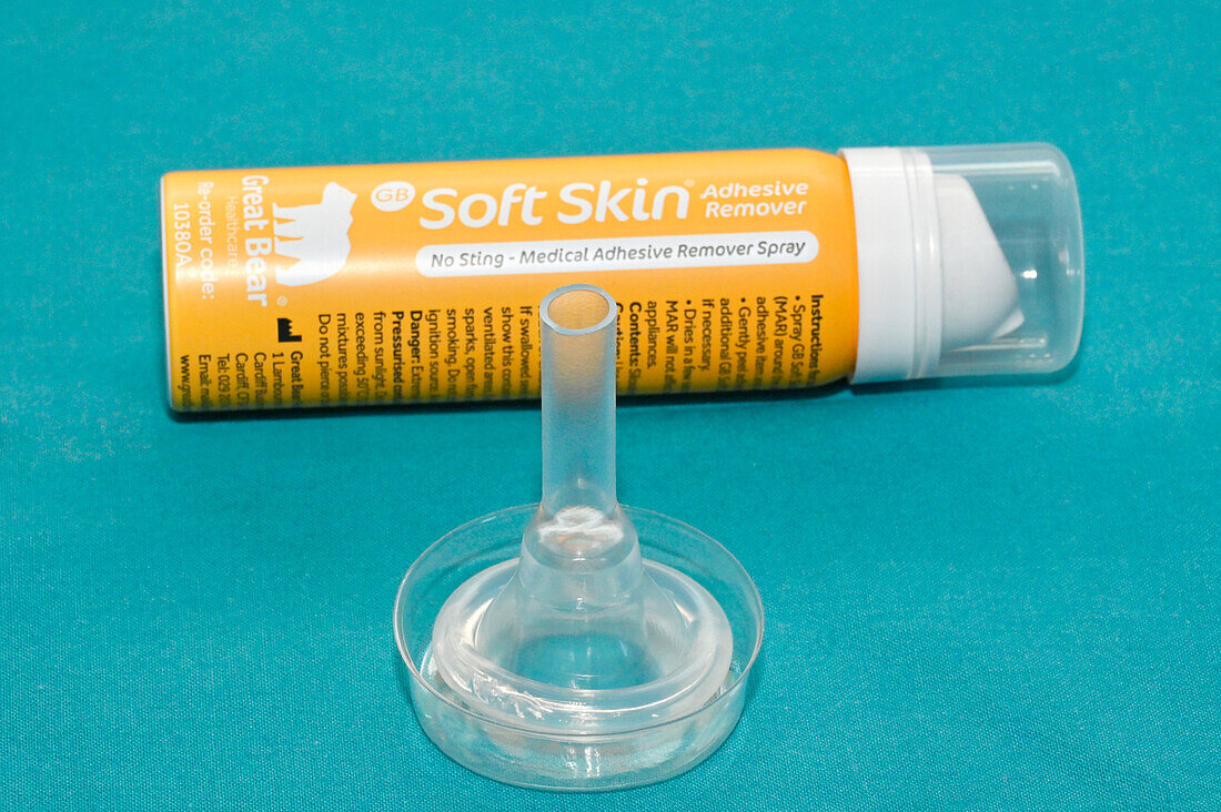 Medical adhesive remover spray with urinary sheath