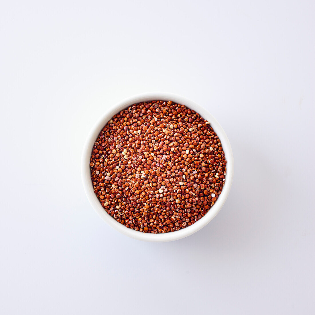 Red quinoa in a white bowl