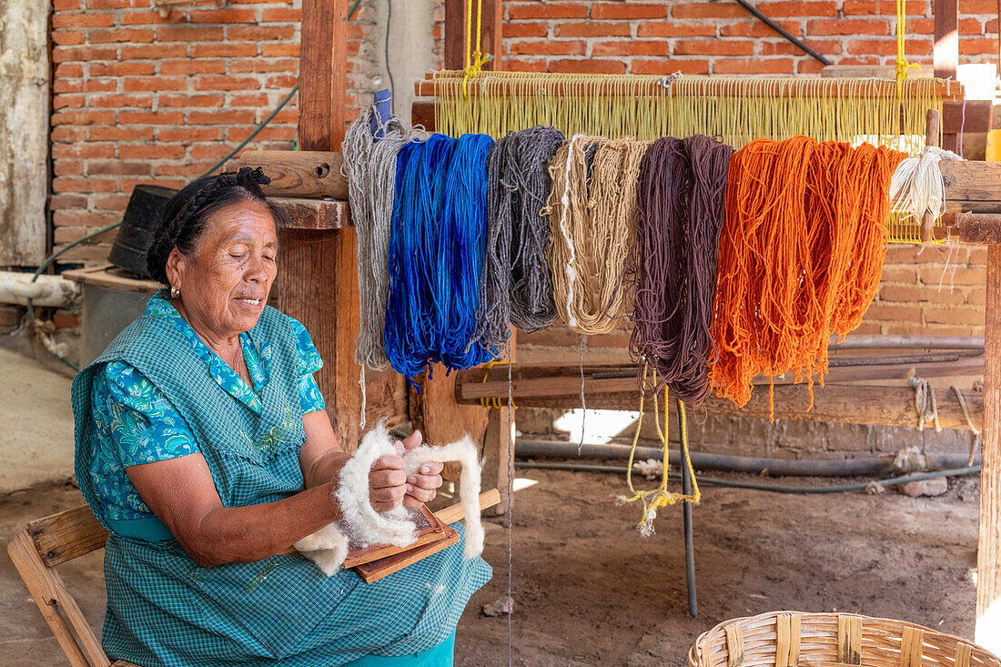 Rural woman showing carded wool