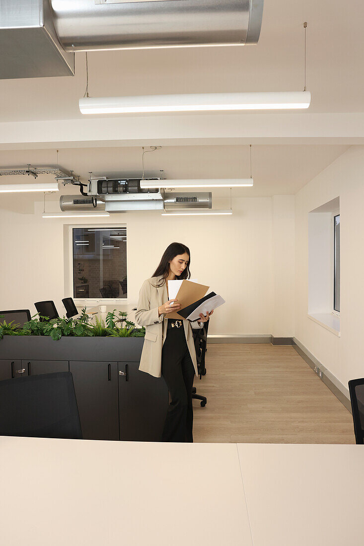 Businesswoman looking at files in conference room