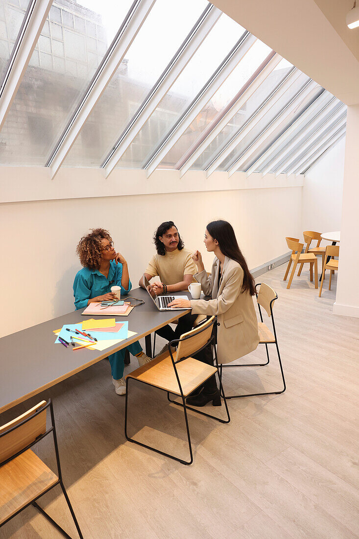 Creative team talking during meeting in modern office