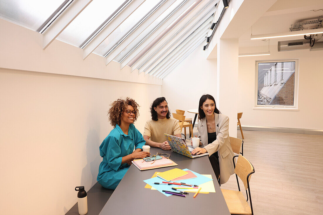 Creative team talking during meeting in modern office