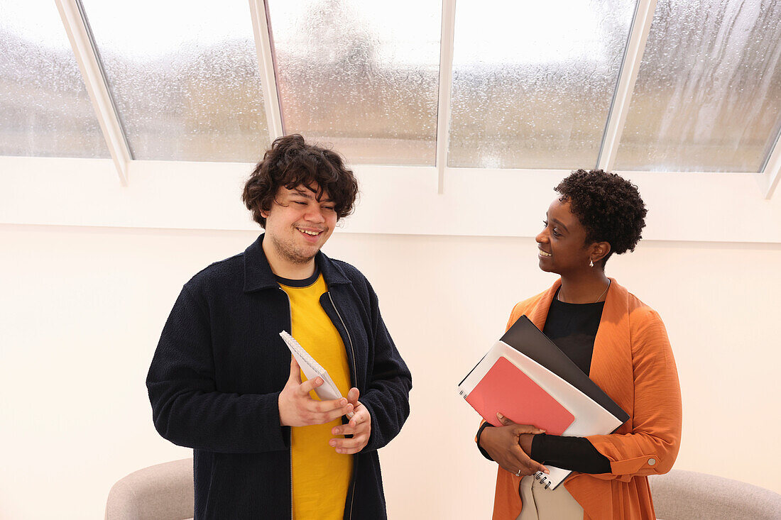 Smiling creative workers talking in studio