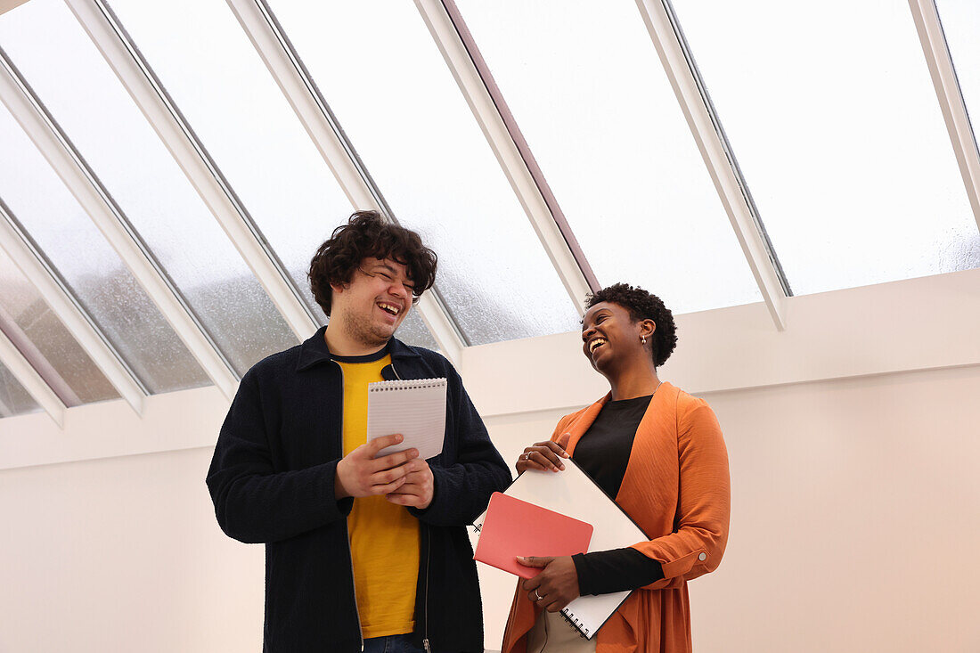 Smiling creative workers talking in studio