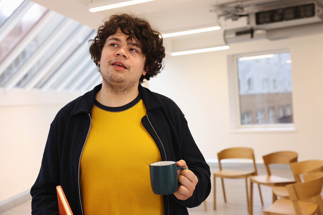 Man with cup in office