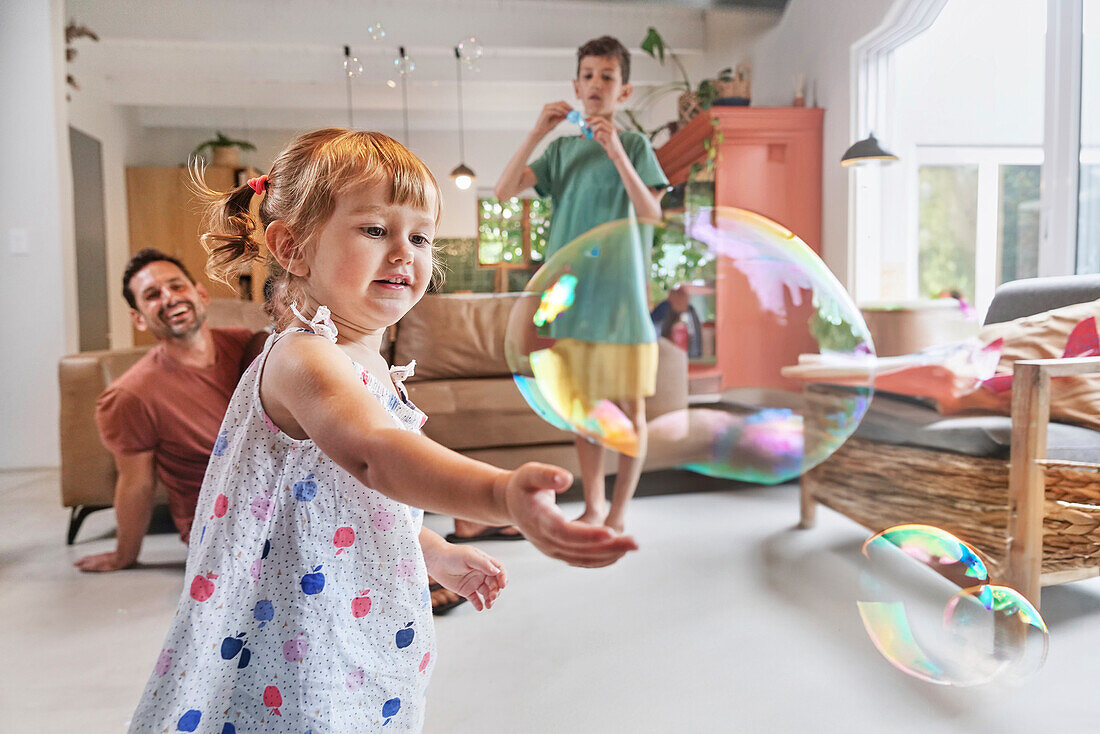 Father with children playing with bubbles