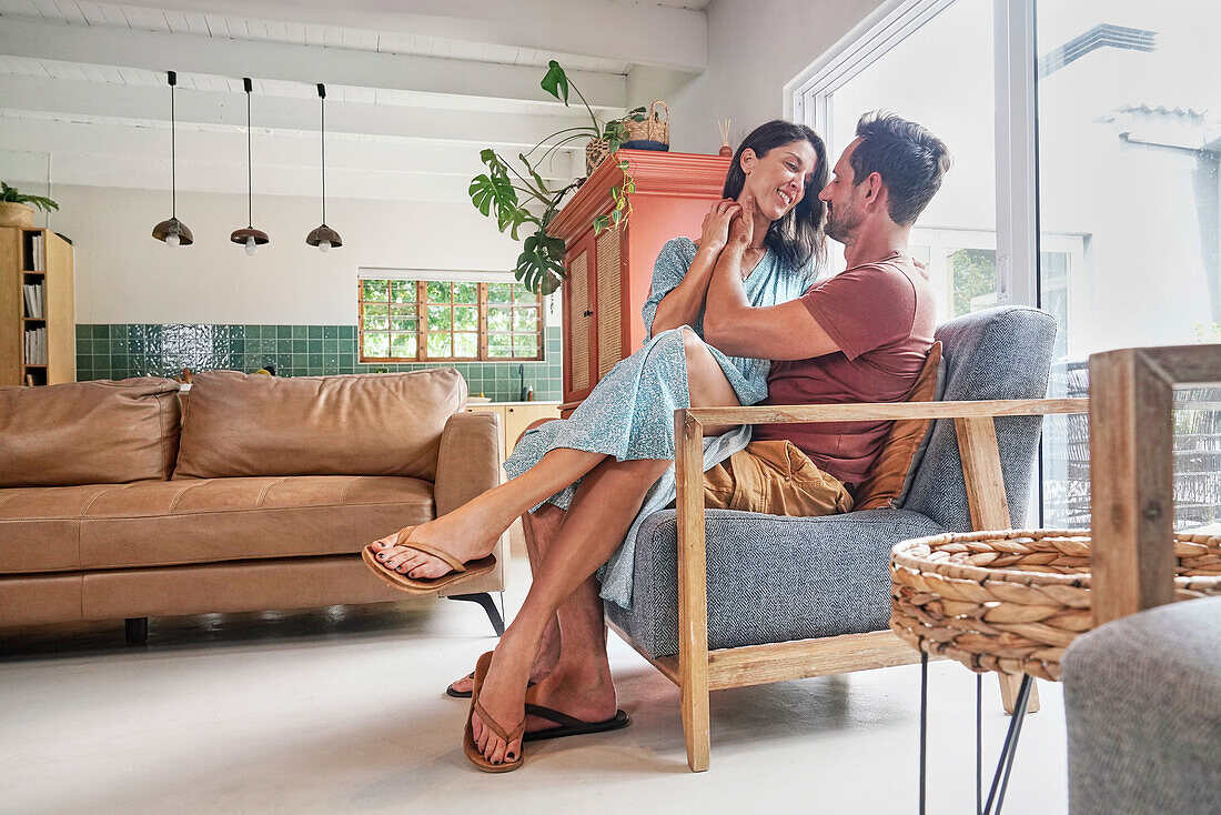 Couple relaxing on armchair