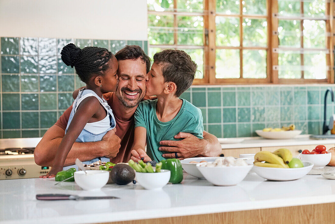 Children kissing in kitchen