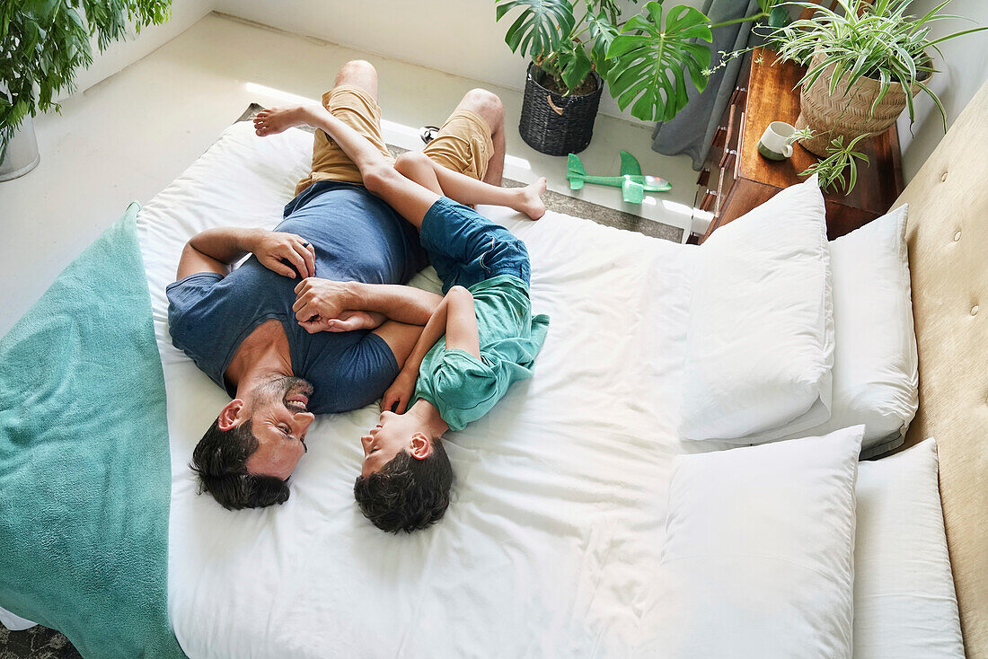 Father and son lying on bed