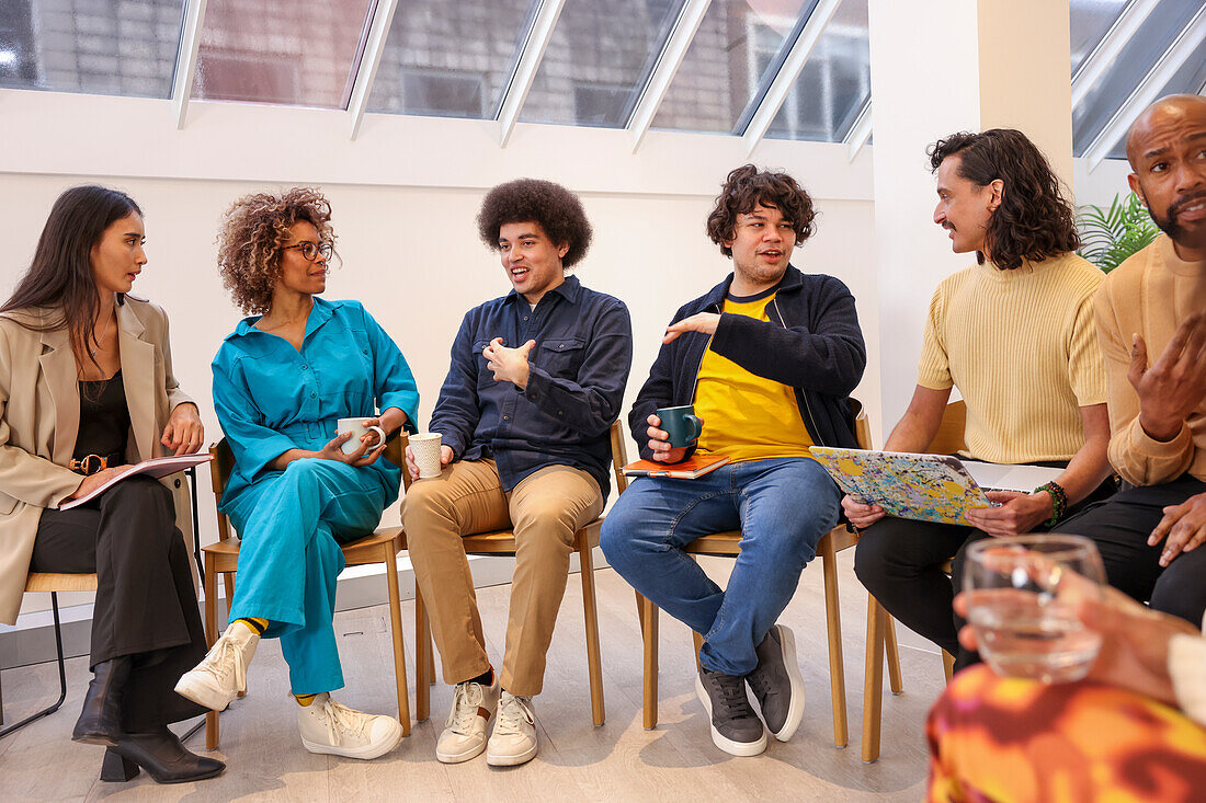 Employees in discussion at team meeting