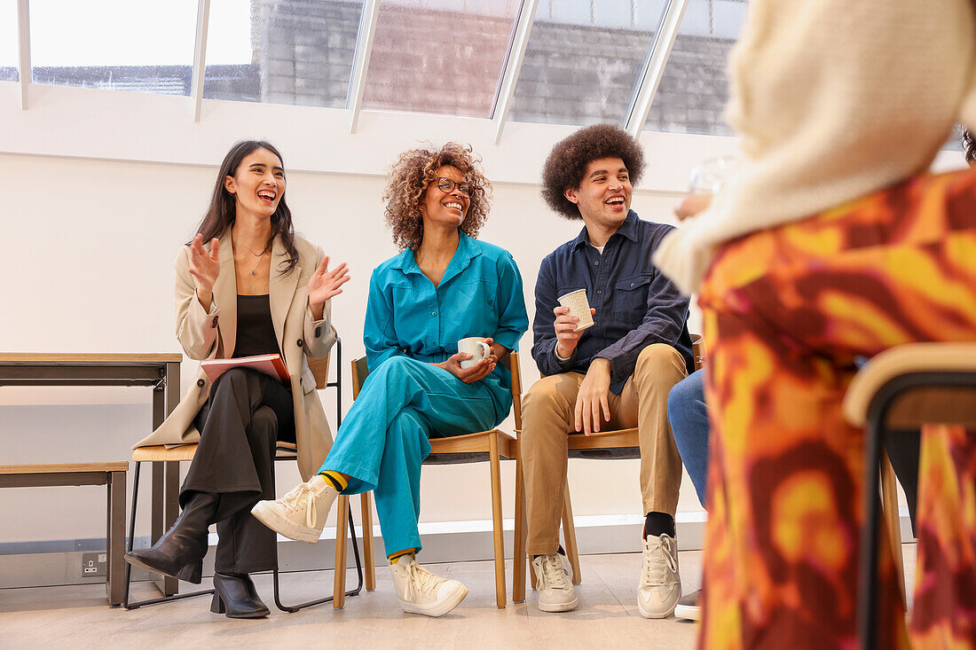 Company employees smiling in team meeting