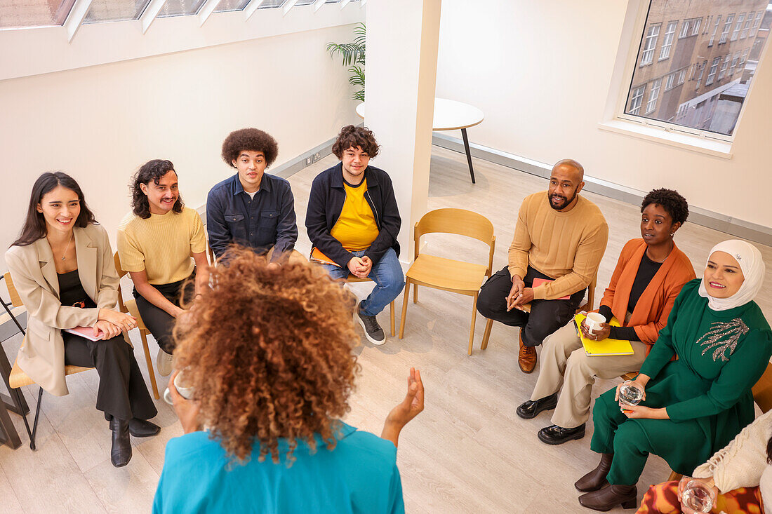 Employee leading discussion in team meeting