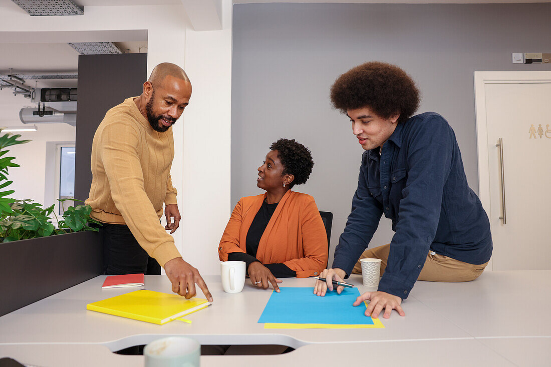 Employees working at desk in office