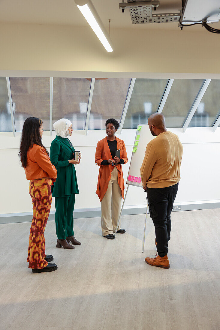 Employees having team meeting in office