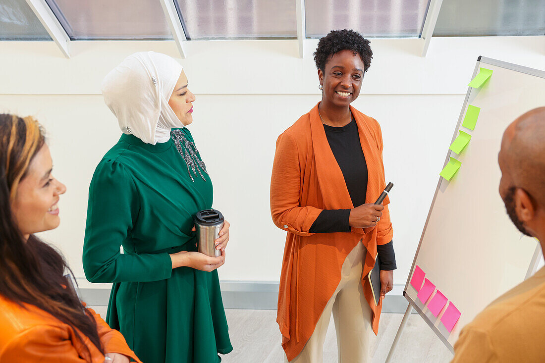 Employees smiling during team meeting in office