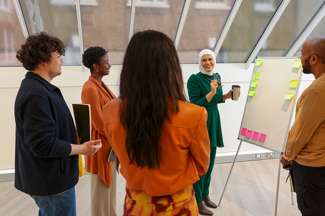 Employees having team meeting in office