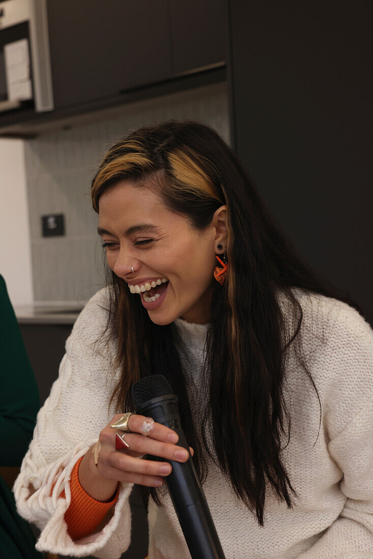 Woman holding microphone and laughing