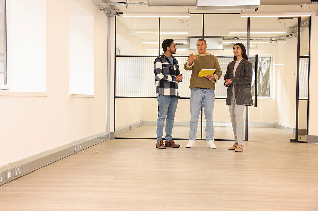 Coworkers talking in empty office