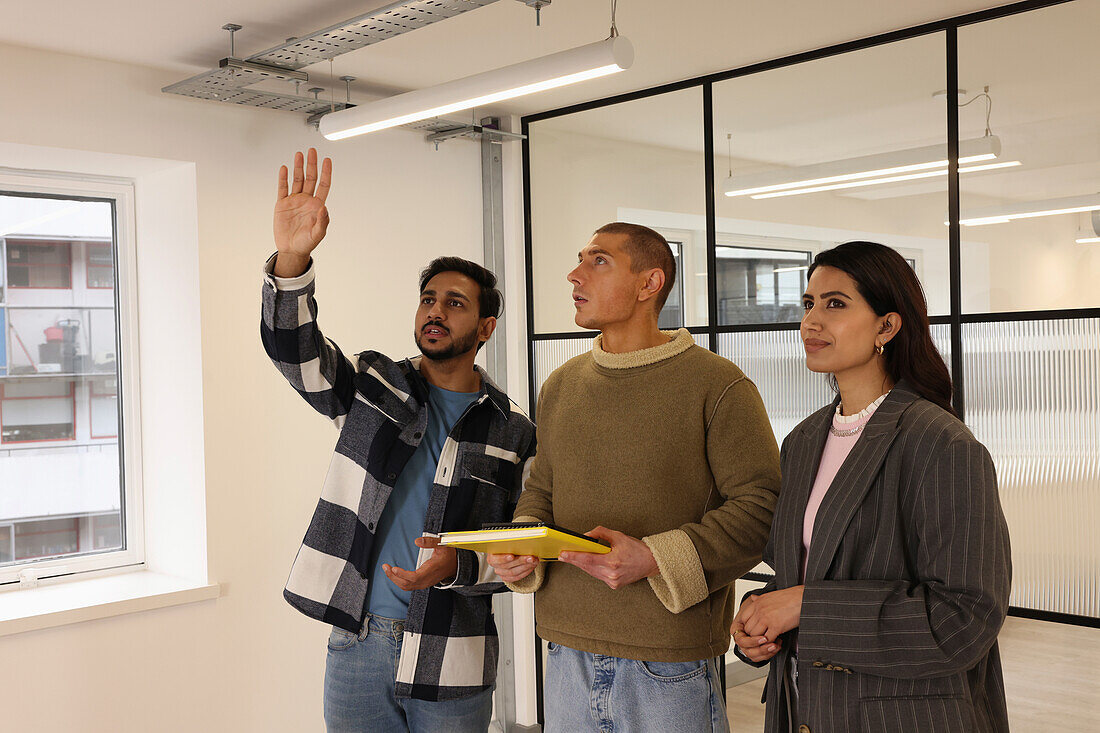 Coworkers talking in empty office