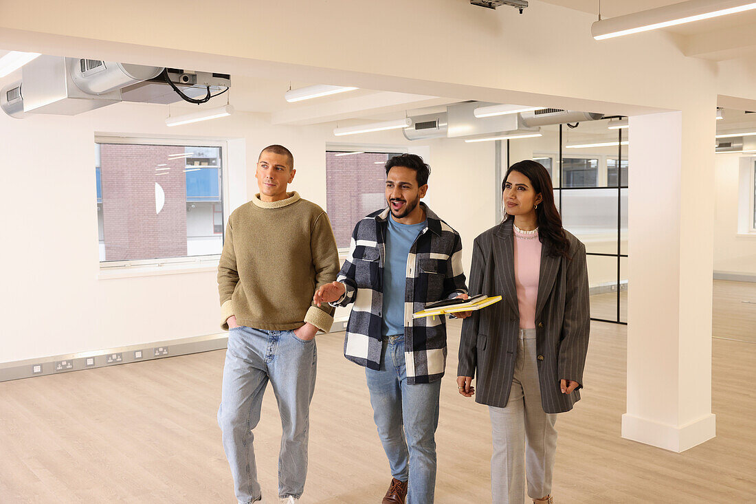 Coworkers talking in empty office