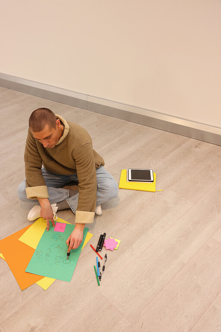 Man sitting on floor in modern office