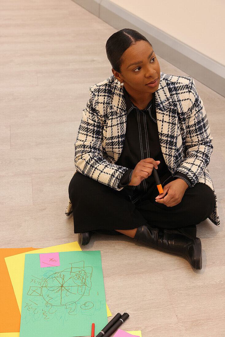 Woman sitting on floor in modern office