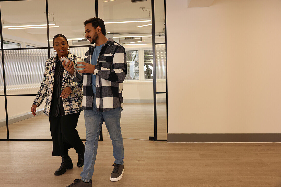 Coworkers walking in office