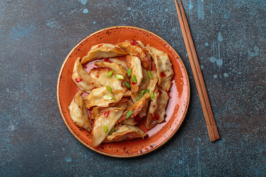 Gyoza dumplings with spring onions and soya sauce