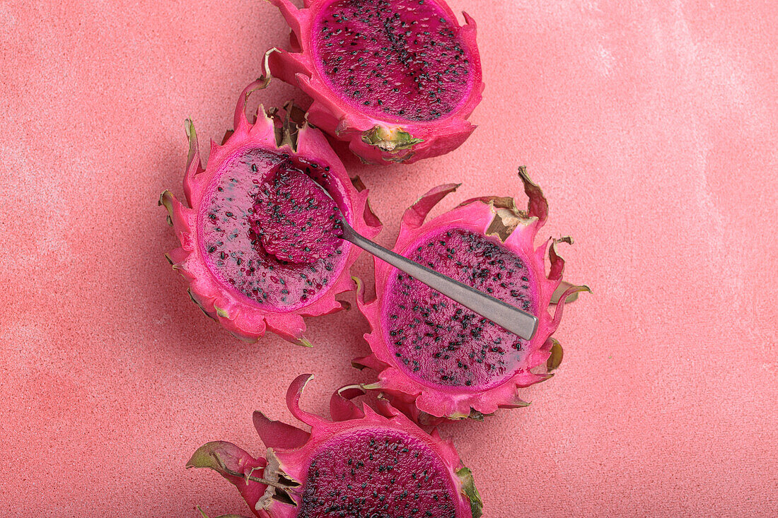 Sliced dragon fruit on a pink background