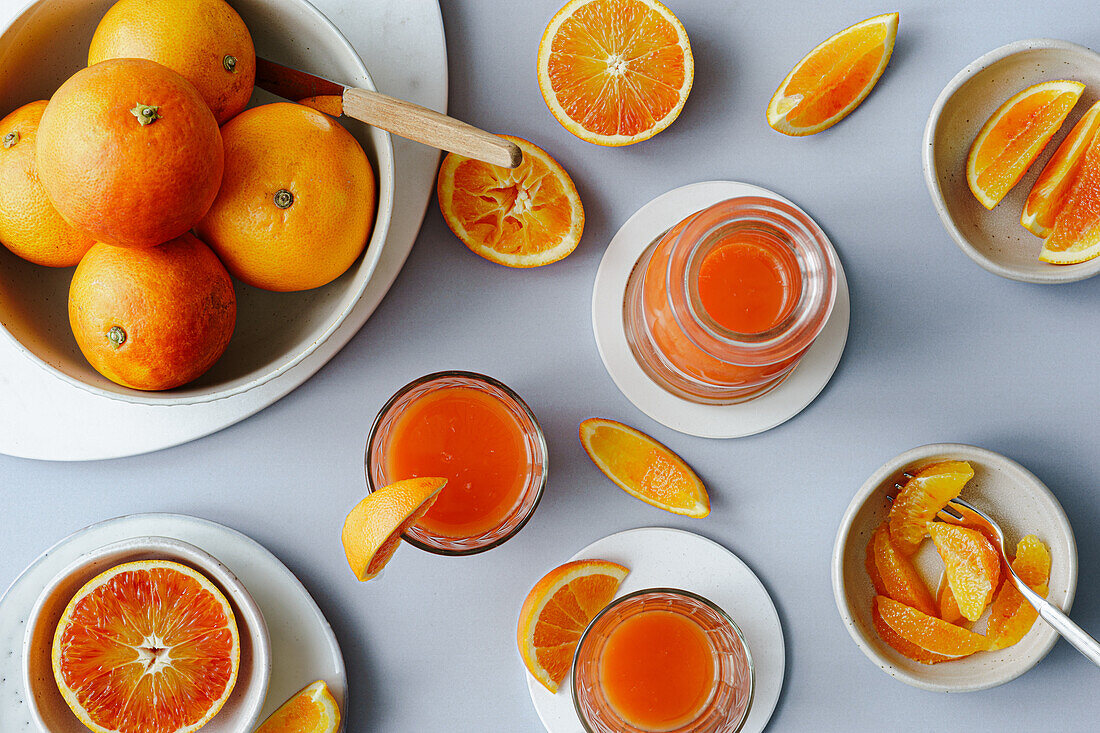 Freshly squeezed blood orange juice with orange wedges