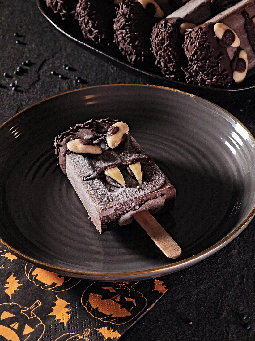 Homemade chocolate ice cream on a stick with Halloween decoration